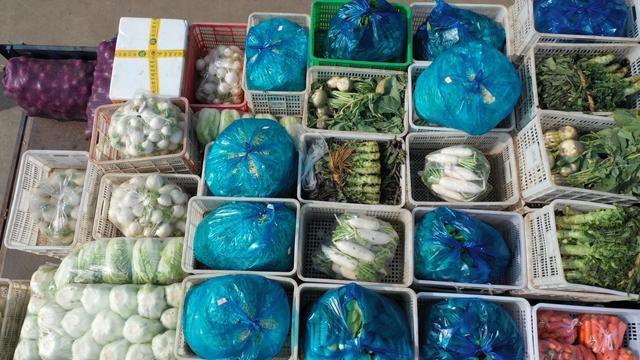 12月10号上午,在北仑区农副产品批发市场内,陈新景夫妇将新鲜蔬菜分类